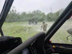Alaska Army National Guard Chief Warrant Officer 3 Nick Lime, an aviator assigned to 207th Aviation Battalion, assists six distressed people stranded on the Kuskokwim River. (Alaska National Guard courtesy photo by Chief Warrant Officer 3 Bryan Kruse)