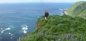 Photo:  Hiker on the edge of a Chirikof Island cliff.
