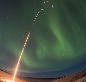 Time lapse photo of the NASA Oriole IV sounding rocket with Aural Spatial Structures Probe as an aurora dances over Alaska. All four stages of the rocket are visible in this image. Image Credit: NASA/Jamie Adkins