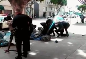 LA Police struggle with homeless man moments before five shots rang out killing the man known by his friends as "Africa."