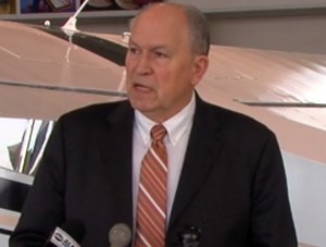 Governor Walker talks to press during layover last month