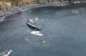 A Coast Guard Air Station Kodiak MH-60 Jayhawk helicopter crew conducts an overflight of the grounded fishing vessel Savannah Ray after reports of a diesel sheen near Kodiak Island,  March 5, 2015. The Savannah Ray initially ran aground Feb. 16, 2015, with four people aboard who were rescued by an aircrew from Air Station Kodiak. (U.S. Coast Guard photo)