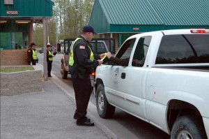 Department of the Army Civilian Police officers check drivers’ identification at the Fort Richardson gate.  Image-U.S. Army