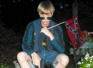 Dylann Roof, the man said to have massacred nine at a bible study class poses with a Confederate flag in a Facebook image.
