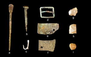 A representative collection of artifacts discovered in July 2015 includes (from left) part of a set of dividers, a nail, a fishhook, a buckle, sheet copper, gun flints and a musket ball. Credit: Dave McMahan, Sitka Historical Society