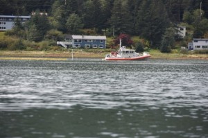 Responders deploy oil containment boom around the sunken tug (All that can be seen is the mast) as it lays on the bottom in Gastineau Channel. Image-Petty Officer 2nd Class Grant DuVuyst/Coast Guard