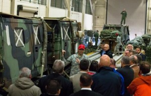 Members of the NATO Support Agency are given a briefing by Chief Warrant Officer 3 Ismael Ramosbarbosa, a senior airdrop systems technician with the 4th Quartermaster Company, Joint Base Elmendorf-Richardson, on small unit support vehicles.(U.S. Army National Guard photo by Sgt. Marisa Lindsay)