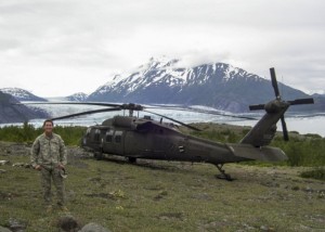 Alaska Guardsman Chief Warrant Officer 4 Pamela Vitt, the command chief warrant officer for the Alaska Army National Guard, stands in front of a UH-60 Black Hawk helicopter near Colony Glacier while supporting a wreckage recovery mission in June. (Photo courtesy Chief Warrant Officer 4 Pamela Vitt)