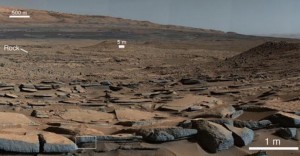 A view from the Kimberley formation looking south. The strata in the foreground dip towards the base of Mount Sharp, indicating the ancient depression that existed before the larger bulk of the mountain formed. Credit: NASA/JPL-Caltech.