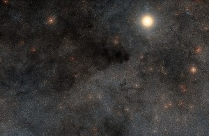 This rich landscape is part of the small constellation of Crux (The Southern Cross). The very bright star is Alpha Crucis, also know as Acrux, one of the four stars that make up the famous cross shape. Most of the upper left part of this image is filled with dark dusty clouds that form part of the huge dark nebula called the Coalsack.  Credit: ESO/Digitized Sky Survey 2. Acknowledgment: Davide De Martin