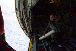 Petty Officer 3rd Class James Abel, an avionics electrical technician from Coast Guard Air Station Kodiak, Alaska, prepares to deploy an oceanic data-collecting probe over the Arctic Circle Aug. 26, 2015.(U.S. Coast Guard photo by Petty Officer 3rd Class Lauren Steenson)