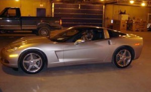 Kilo sits in a brand-new Corvette seized during a Fairbanks drug case he played an instrumental part in.  Image-Trooper Times