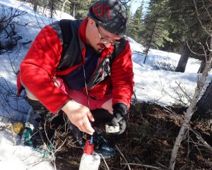 Amir Allam of the University of Utah and UAF installs a temporary seismometer near the Denali Fault between Delta Junction and Glennallen. Image-Ned Rozell