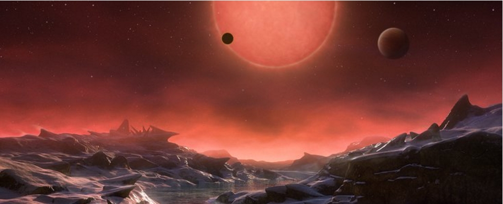 This artist’s impression shows an imagined view from the surface one of the three planets orbiting an ultracool dwarf star just 40 light-years from Earth that were discovered using the TRAPPIST telescope at ESO’s La Silla Observatory. Credit: ESO/M. Kornmesser