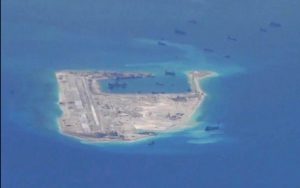 Chinese dredging vessels seen around Fiery Cross Reef in the Spratly Islands in image taken by U.S. Navy P-8A Poseidon aircraft. Navy Handout via Reuters