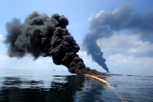 Dark clouds of smoke and fire emerge as oil burns during a controlled fire in the Gulf of Mexico, 6 May 2010. A new study found black carbon left from the burns joined a “dirty blizzard” of contaminants that eventually settled on the seafloor. Photo: U.S. Navy
