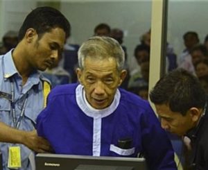 FILE - Kaing Guek Eav, alias Duch, who ran a prison where up to 16,000 people were tortured before being killed, comes before the Khmer Rouge war crimes tribunal in Phnom Penh, Cambodia, March 19, 2012.