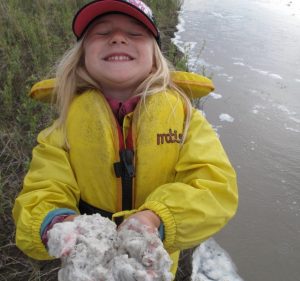 A girl with foam that was floating on the Tanana River. Photo by Ned Rozell.