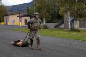 Spc. Trent Marnell, a military policeman with the 49th Missile Defense Battalion, Alaska Army National Guard, participates in the casualty evacuation event during the Best Warrior Competition.(Army National Guard photo by Officer Candidate Marisa Lindsay)