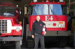 Gakona Volunteer Fire Department Chief Jason Severs accepted the fire  extinguishers donated by HAARP. Photo by Marty Karjala.