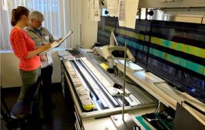 Elise Chenot, of the Université de Bourgogne-Franche Comté, left, and Michael Whalen, of the UAF Geophysical Institute, examine a rock core from the Chicxulub crater in a lab in Bremen, Germany. Photo by Kevin Kurtz