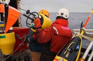 Preparing to drop a buoy in the Arctic Ocean. Image-Jim Thompson University of Washington/Applied Physics Laboratory