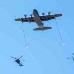 Two HH-60G Pave Hawks and an HC-130J Combat King II perform aerial refueling. Image-U.S. Air Force