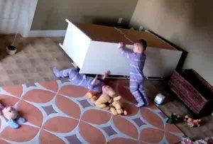 2-year-old Bowdy Shoff works to free his twin brother from under fallen dresser. Image-Kayli Shoff