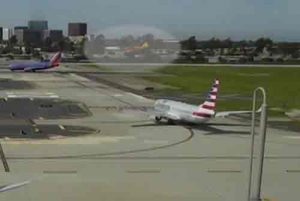 Airport cameras captured Harrison Ford's aircraft overflying an American Airlines passenger jet at Orange County's John Wayne Airport.