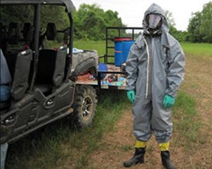 Investigating cases that involve the unlawful use of poisons is hazardous. The photo shows the special agent wearing a protective suit while investigating this case. Credit: USFWS