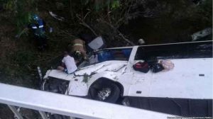 Rescuers work to free victims from inside the overturned bus in Anton, Cocle, Panama.