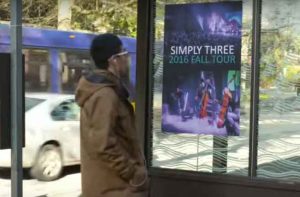 UW researchers used FM radio signals to broadcast music and data notifications from a Simply Three band poster at a Seattle bus stop to a smartphone. An antenna made of copper tape was embedded on the back of the poster.University of Washington