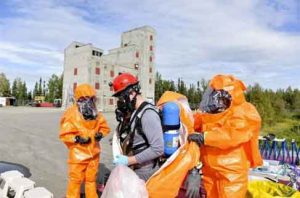 U.S. Army Staff Sgt. Andrew Markham, an Alaska Army National Guard Chemical, Biological, Radiological, Nuclear and Environmental technician, gears up in 2016 exercise. Image-U.S. Air Force/ Airman Isaac Johnson