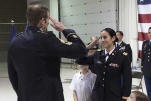 2nd Lt. Marisa Lindsay receives her first salute as an officer from Master Sgt. Michael Lindsay, Special Forces Advisor with the 1-196th Infantry Regiment, during a commissioning ceremony at the National Guard armory on JBER. Lindsay will serve as a platoon leader for E Company, 207th Aviation Regiment. (U.S. Army National Guard photo by Spc. Michael Risinger)