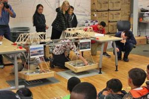 Middle School Academy Students load testing different bridge builds. Image-ANSEP
