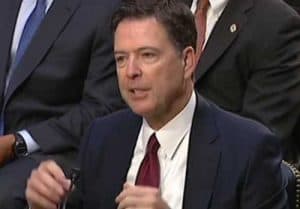 Former FBI Director James Comey testifying to lawmakers on the Hill. Image-VOA