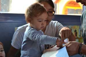 UW student Jinnie Yi works with a toddler at one of the participating infant education centers in Madrid.I-LABS