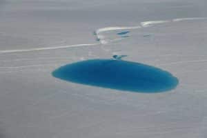 One of the dozen supraglacial lakes that Operation IceBridge surveyed to measure lake depth on July 19, 2017. Credits:  NASA/John Sonntag