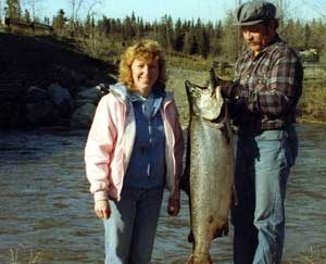 Two Alaska anglers with a freshly caught King Salmon. Image-USFWS