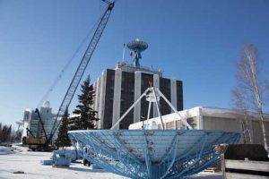 The new AS-2 antenna stands atop the Elvey building at the University of Alaska Fairbanks. In the foreground rests the old AS-2 antenna it replaced. Credits: Jeff Beiderbeck/PWP Photography