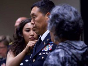 Alaska Army National Guard Col. Wayne Don, 38th Troop Command commander, looks on as his daughter, Phylicia (left), and mother, Annie, pin on full colonel rank insignia. (U.S. Army photo by Sgt. David Bedard)