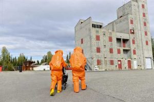 U.S. Air Force Senior Airman Eric McComb and U.S. Army Staff Sgt. Andrew Markham, both Chemical, Biological, Radiological and Nuclear (CBRN) technicians with the 103rd Weapons of Mass Destruction-Civil Support Team (WMD-CST), out of Kulis Air National Guard Base, Alaska, walk toward a building with potential CBRN threats Aug. 23, 2016, at the Fairbanks Regional Fire Training Center in Fairbanks, Image-Airman Isaac Johnson