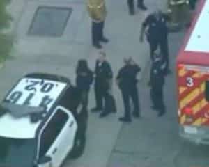 LAPD officers escorting the 12-year-old shooting suspect to patrol vehicle. Image-KTLA video screenshot