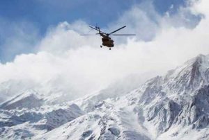 In this photo provided by Tasnim News Agency, a rescue helicopter flies over the Dena mountains while searching for wreckage of a plane in southern Iran, Feb. 19, 2018.