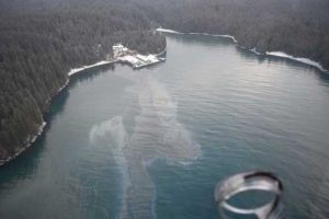 A Coast Guard Air Station Kodiak MH-60 helicopter crew and Marine Safety Detachment Kodiak pollution responders conduct an overflight in response to an oil spill in Shuyak Strait. USCG photo