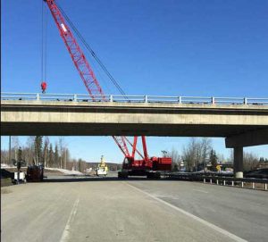 Crane being positioned on the Glenn Highway for removal of the damaged bridge girder. Image-DOT