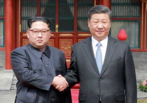 North Korean leader Kim Jong Un shakes hands with Chinese President Xi Jinping in Beijing, as he paid an unofficial visit to China, in this undated photo released by North Korea's Korean Central News Agency in Pyongyang, March 28, 2018.