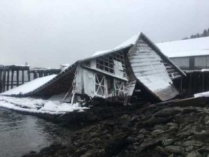 Remaining debris of a collapsed building resulting in an oil spill is shown in Port William, Alaska, March 14. Photo courtesy of Global Diving and Salvage