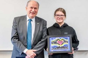 Governor Walker with Eva Easton with her "Safer Alaska" poster entry. Image-State of Aalska