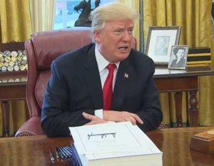 Trump at massive tax cut signing. Image-screengrab